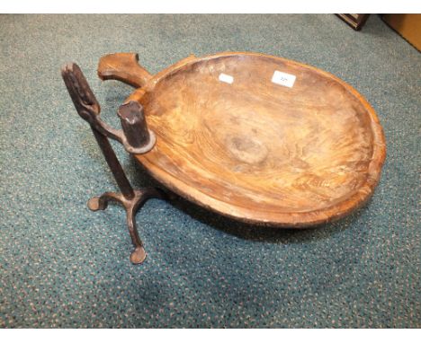 A vernacular stained and carved elm handled pan, 35cm wide and an 18th/19th century iron combined candlestick and rush nip on