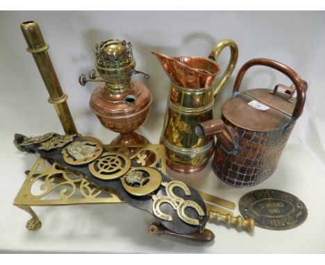 Metal wares including a copper watering can, a copper and brass jug, copper oil lamp, brass footman, brass candlestick, set o