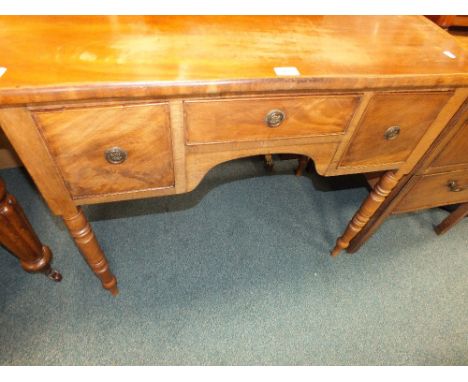 A 19th century mahogany side table with frieze drawer over a shaped apron flanked by two short drawers on ring turned taperin