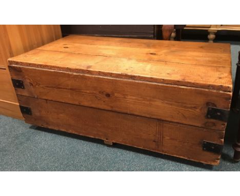 A metal bound pine trunk with lined interior, 107cm wide, 57cm deep, 44cm high