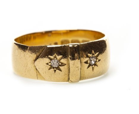 DIAMOND SET BELT MOTIF RING, with two star set diamonds of approximately 0.03 carats each, 7.6mm wide, in eighteen carat gold