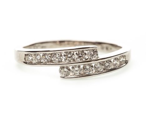 DIAMOND DRESS RING, the crossover bezel with channel set round brilliant cut diamonds totalling approximately 0.60 carats, in