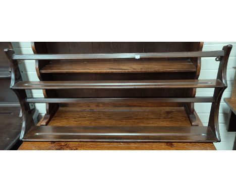 An Ercol dark oak pair of delft racks.&nbsp;&nbsp;Fitted three shelves internally.&nbsp; Fixed to wall by 2 brass brackets.