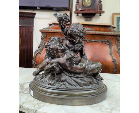 A bronze table lamp in the form of two entwined bacchanal putti, height of figures, 28 cm.&nbsp;&nbsp;This lamp is in good co