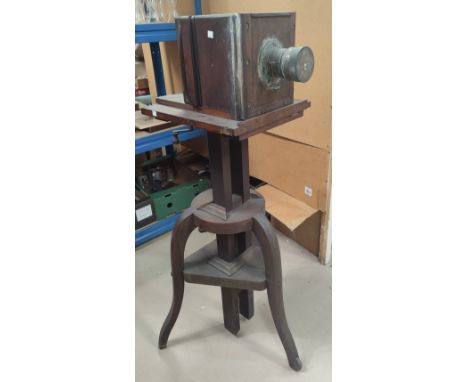 A Victorian mahogany and brass large plate camera on stand (a.f.) The camera is closed (winder stuck0 and measures 24 x 24 x 
