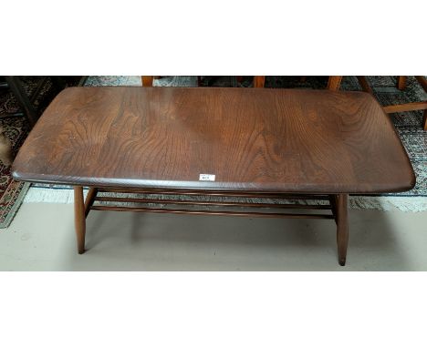 An Ercol dark oak 2 tier coffee table.&nbsp;&nbsp;In good condition with original finish.