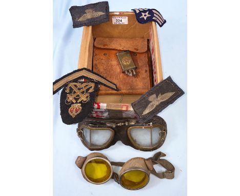A pair of aluminum framed goggles with yellow tint lenses, another pair, a trench art lighter etc 