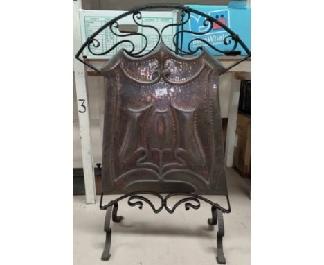 An Art Nouveau firescreen in beaten copper and wrought iron; a mirror firescreen 