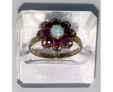 A vintage opal &amp; almondine garnet yellow gold cluster ring, comprising of a central round opal surround by 8 garnets, 9ct