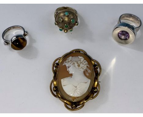 A gilt modernist ring with domed top, set with 9 turquoise coloured stones, stamped 925; a tigers eye set white metal ring st