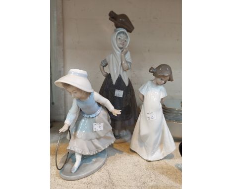 A Nao figure of a girl with balancing water jugs, H; 31cm;  A Nao figure of a young girl + a Nao figure of a young girl with 