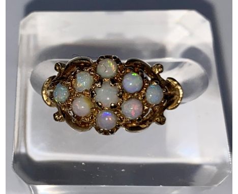 A 9 carat hallmarked gold dress ring set 9 opal coloured stones, 3 gm, size K (1 stone slight chip) 