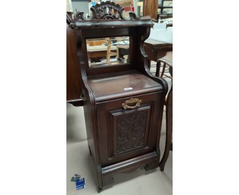 An Edwardian carved mahogany fall front coal box with mirror and shelf over 