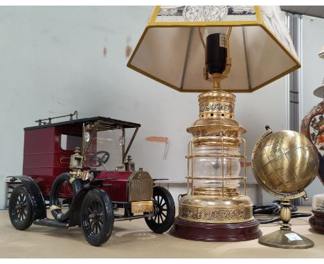 A table lamp in the form of a ship's light; a vintage model van; a small brass globe 