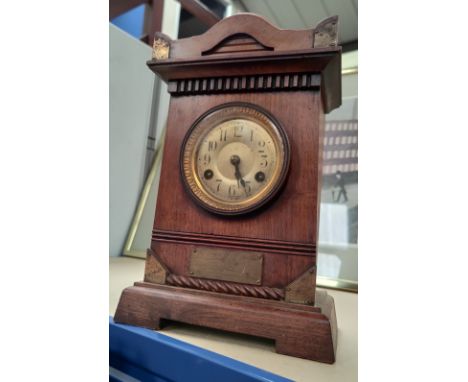 An Edwardian stained wood cased mantel clock 