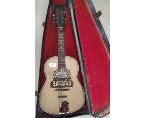 An Anglo-Neapolitan guitar shaped mandolin with portrait to the reverse, cased 