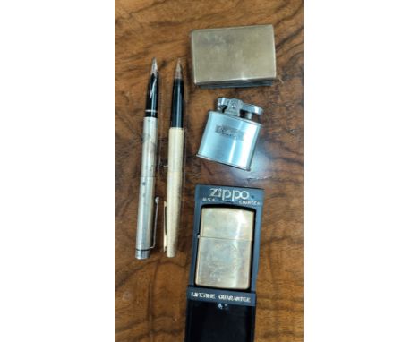 A sterling silver cased Shaffer fountain pen with 14ct gold nib, another Shaffer fountain pen with gilt case and 14ct nib, a 