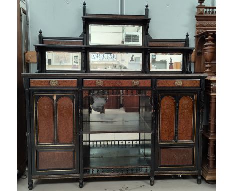 An ebonised and walnut mirror back side unit with 2 cupboards, 3 drawers, central shelf space with 4 bevelled mirrors above l