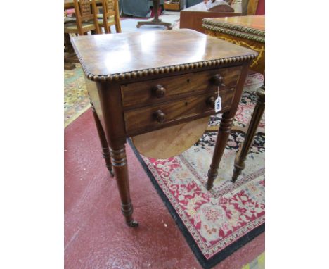 William IV mahogany sewing table featuring two drawers and sliding sewing bag. On four ring turned supports with original bra