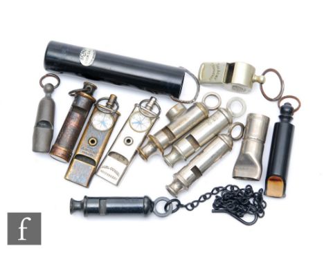 A collection of Acme patent and other whistles including a Boy Scout and two Girl Guide whistles, each mounted with a compass