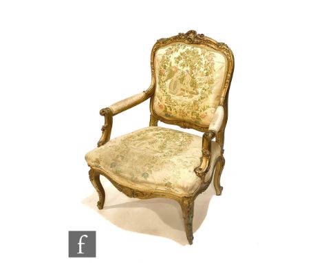 A late 19th to early 20th Century gilt painted French fauteuil elbow easy chair on cabriole legs to the front and back, uphol