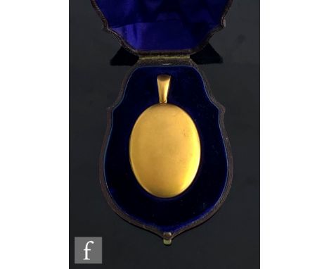 A cased 19th Century 15ct oval locket of plain form opening to a portrait miniature of a lady and a gentleman, weight 34g, le