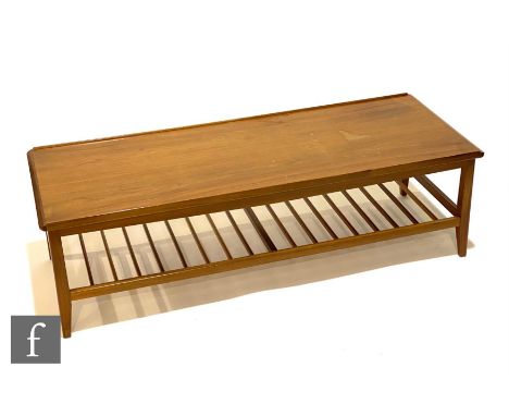 A 1960s teak coffee table of rectangular form with ladder type magazine rack below, unlabelled, height 37cm, length 124cm and