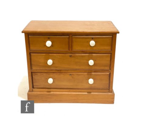 A small Victorian pine dressing chest of two short and two long drawers, white ceramic handles, on a plinth base, height 78cm