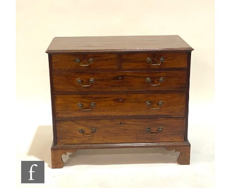 A George III mahogany straight front chest of two short and three long drawers, brass swan neck drop handles, on bracket feet
