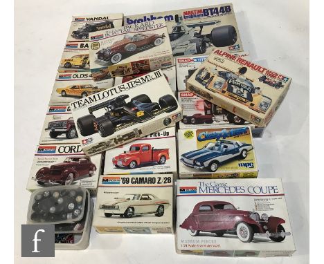 A collection of kit built plastic model cars, mainly Monogram but includes others, along with various spare parts and fourtee