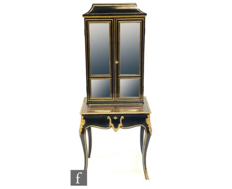 A 19th Century French ebonised and brass inlaid vitrine, enclosed by a pair of glazed doors below a caddy top over a base fit