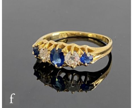 An early 20th Century 18ct hallmarked sapphire and old cut diamond five stone ring, claw set alternating stones, to plain sho