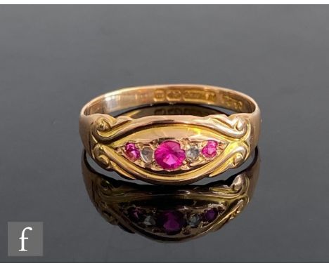 An early 20th Century 15ct ruby and diamond boat shaped ring to scroll shoulders, weight 2.2g, ring size O, Birmingham 1896. 