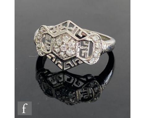 An 18ct white gold diamond cluster ring, central daisy cluster within a pierced gold border and diamond set shoulders weight 