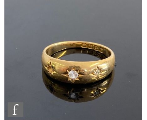 An 18ct hallmarked three stone ring, gypsy set diamond, paste and one stone missing, weight 4.7g, ring size O, Chester 1916. 