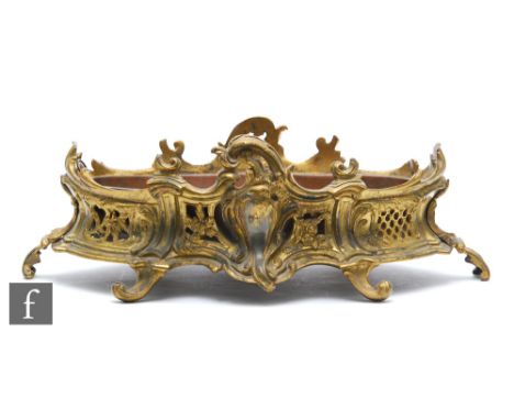 A late 19th Century French gilt metal planter of oval pierced acanthus form, on scroll feet, complete with liner, width 50cm.