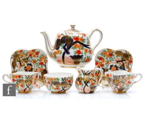 A late 19th Century Coalport tea for two decorated with an Imari pattern comprising teapot, two lobed cups and saucers, milk 