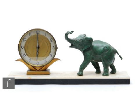 A 20th Century French Art Deco mantle clock with circular dial and Arabic numbers, decorated with a stylised figure of a gree