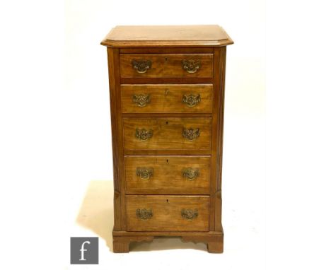 A 20th Century mahogany chest of five drawers of narrow proportions, brass fret drop handles, flanked by canted reeded sides,