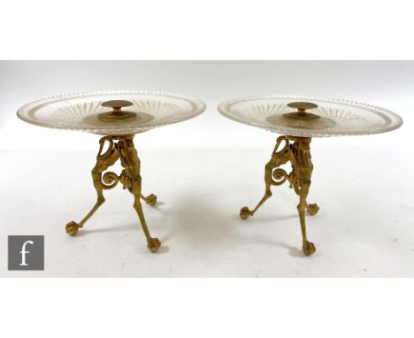 A pair of early 20th Century tazzas with cut glass dishes raised on tripod ormolu bases, height 18cm.