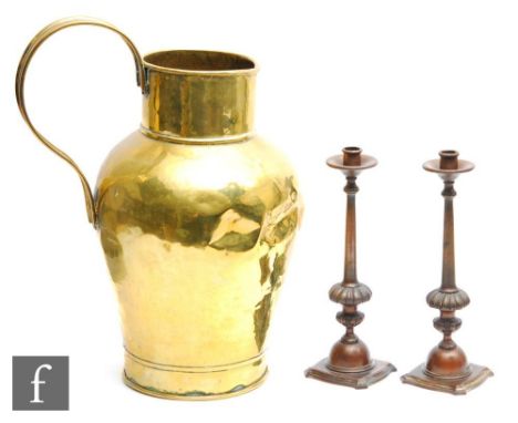 A pair of 20th Century bronzed candlesticks, tapering columns over stylised and foliate bases, height 30cm, and a large brass
