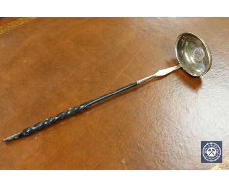 A Georgian silver toddy ladle, inset with a George II six pence dated 1743.