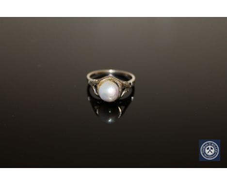 An early twentieth century pearl ring mounted in white metal stamped 18K, size I.