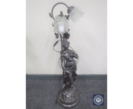 A two-way lamp modelled as a lady standing by a stump