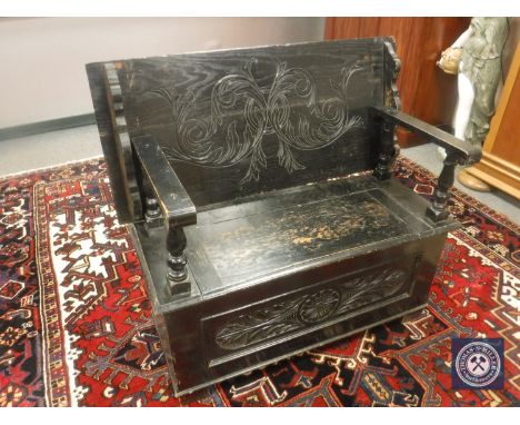 A 19th century stained oak monk's bench, width 107cm