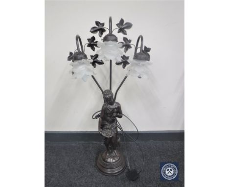 An ornate three-way lamp modelled as a lady holding a basket 