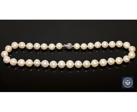 A 14ct white gold pearl and diamond necklace, thirty-five South Sea pearls, white with silver overtones, the filigree clasp w