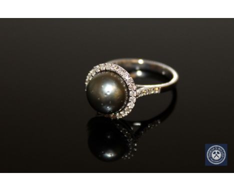 A 14ct yellow gold pearl and diamond ring, the black/grey Tahitian pearl within a border of thirty-five brilliant-cut diamond