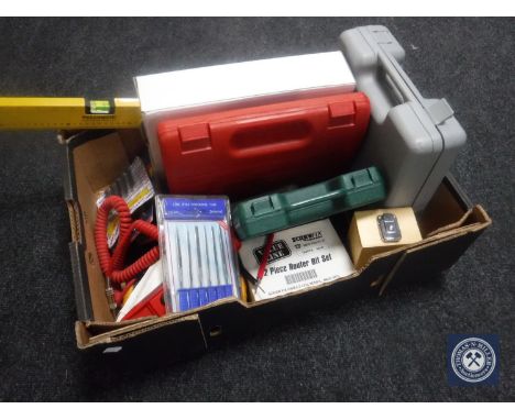 A box containing electrical tools, spirit level, cased drill, electrical testing meter, ratchet etc