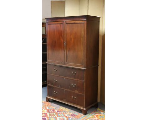 A late 18th century-style mahogany small linen press fitted two adjustable sliding trays enclosed by pair of fielded panel do